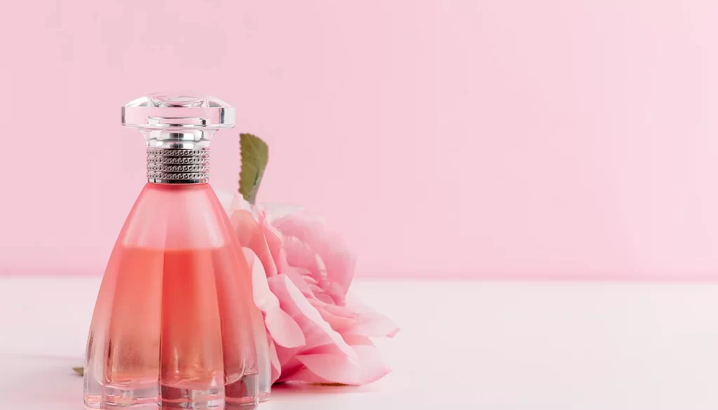 bottle-of-perfume-with-flowers-on-color-background-2021-09-03-10-32-01-utc