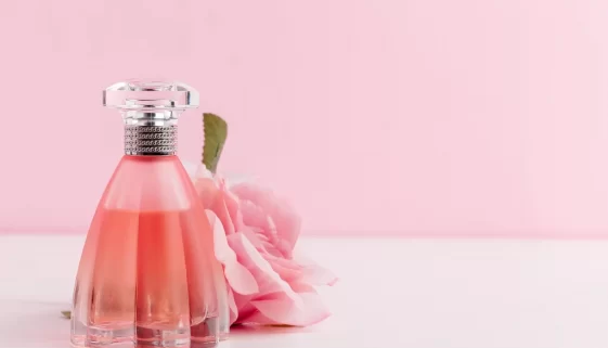 bottle-of-perfume-with-flowers-on-color-background-2021-09-03-10-32-01-utc